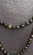 Collier formant sautoir composé de 154 perles de Tahiti grises, bleu-vertes